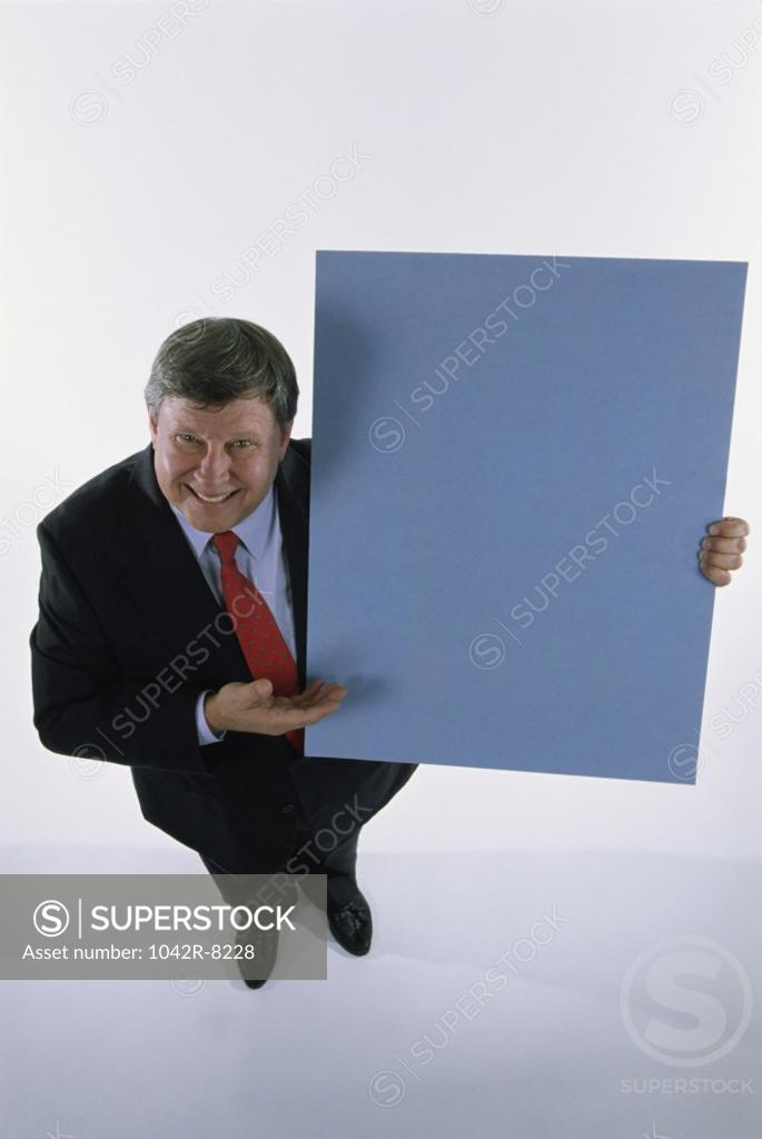 Stock Photo: 1042R-8228 Portrait of a businessman holding a placard