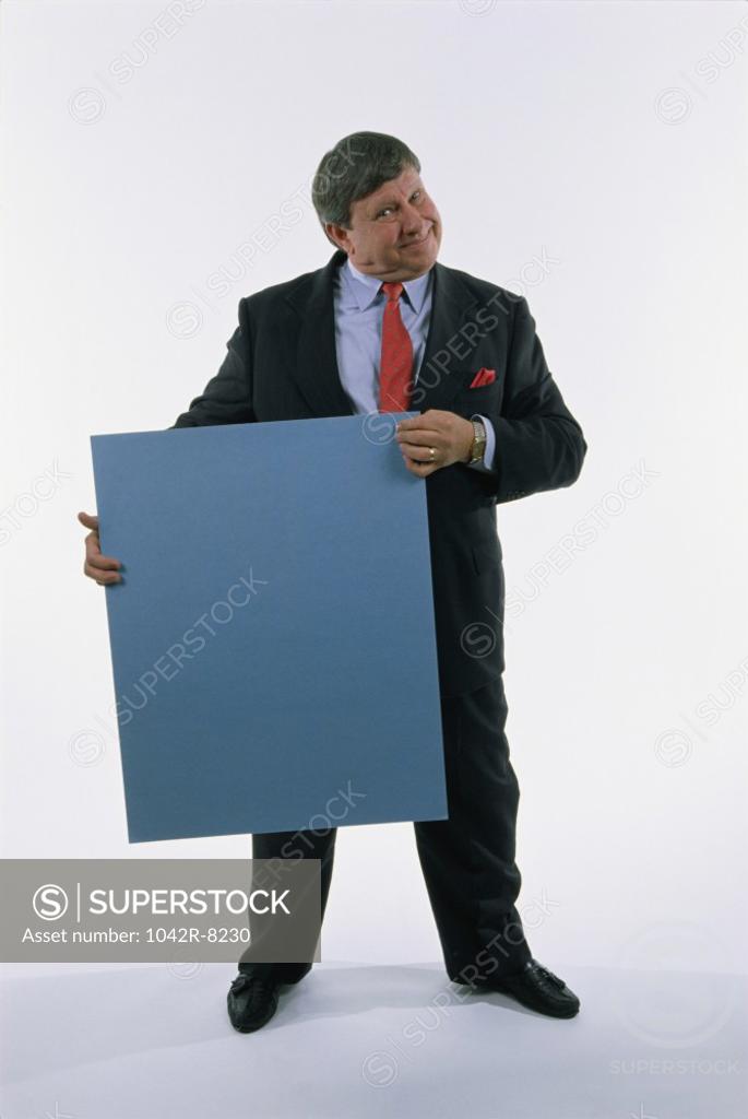 Stock Photo: 1042R-8230 Portrait of a businessman holding a placard