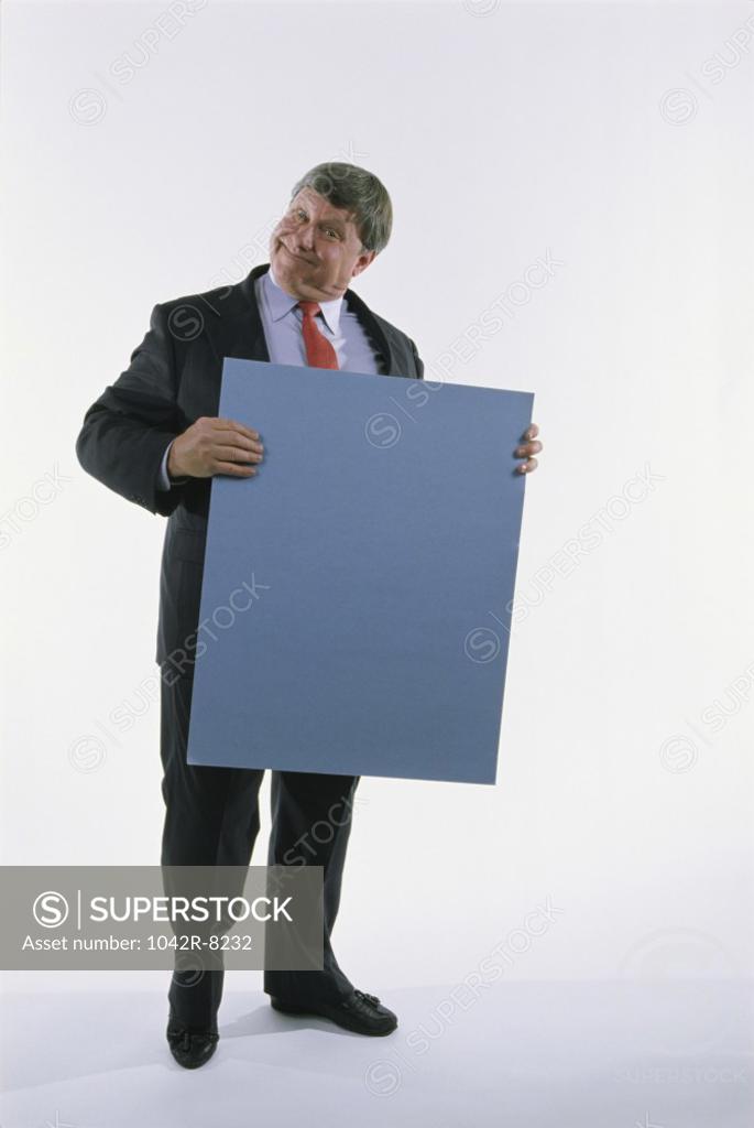 Stock Photo: 1042R-8232 Portrait of a businessman holding a placard