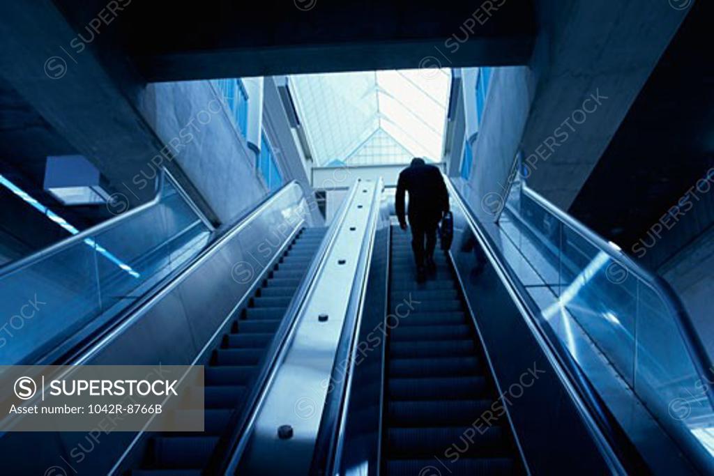 Stock Photo: 1042R-8766B Rear view of a businessman on an escalator