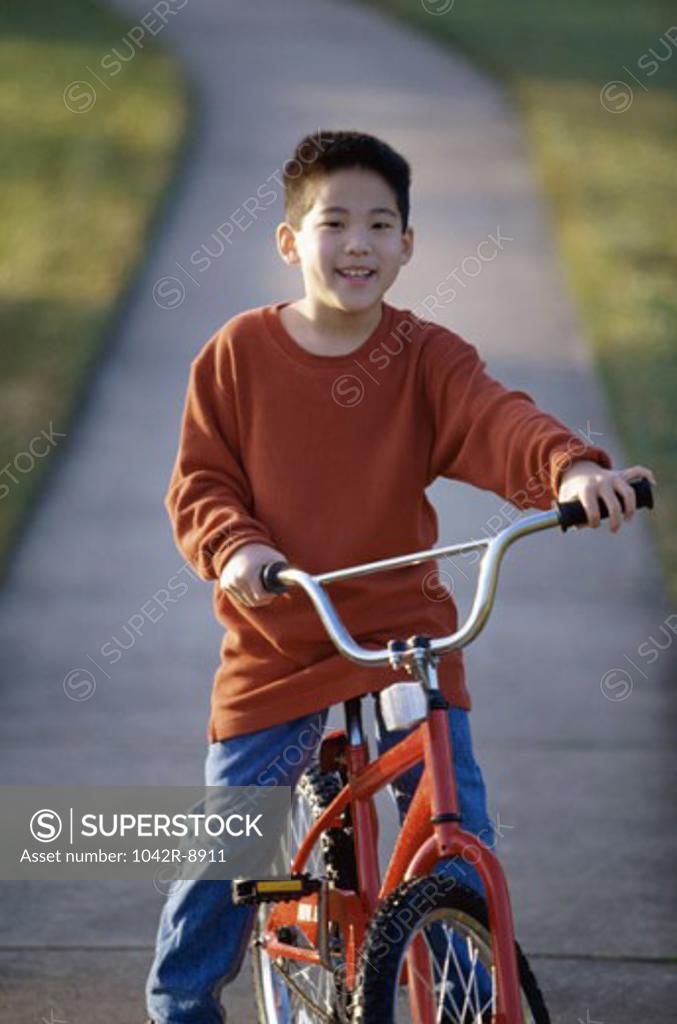 Stock Photo: 1042R-8911 Portrait of a boy sitting on a bicycle