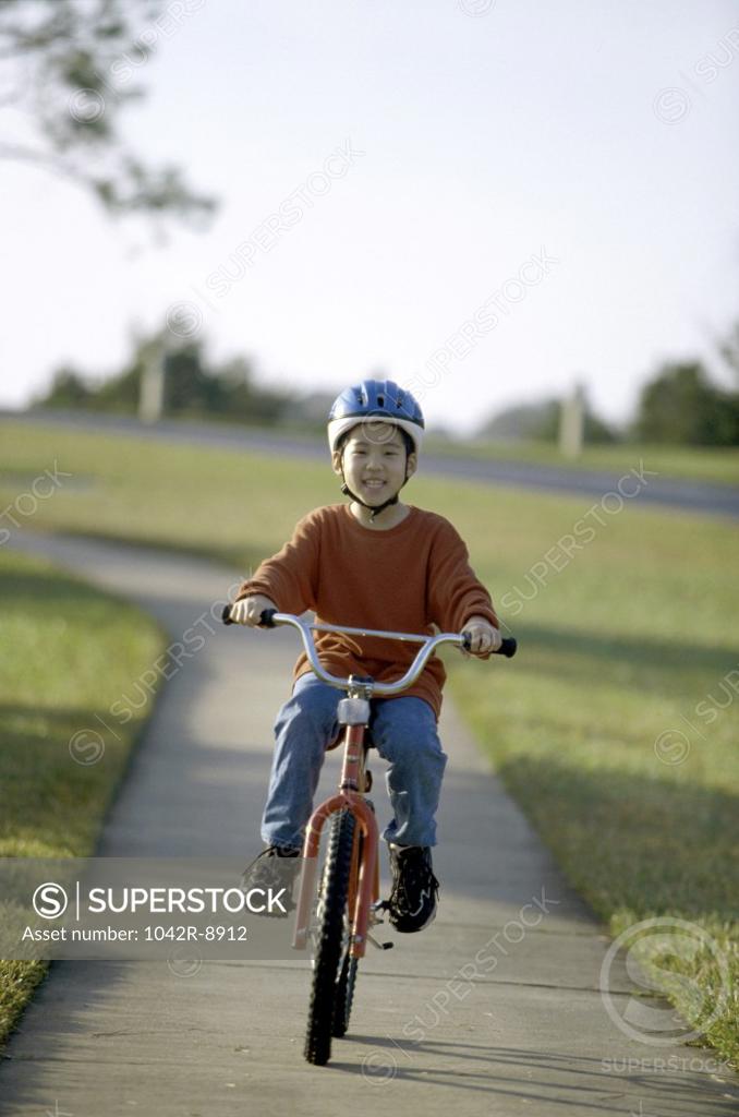 Stock Photo: 1042R-8912 Portrait of a boy riding a bicycle