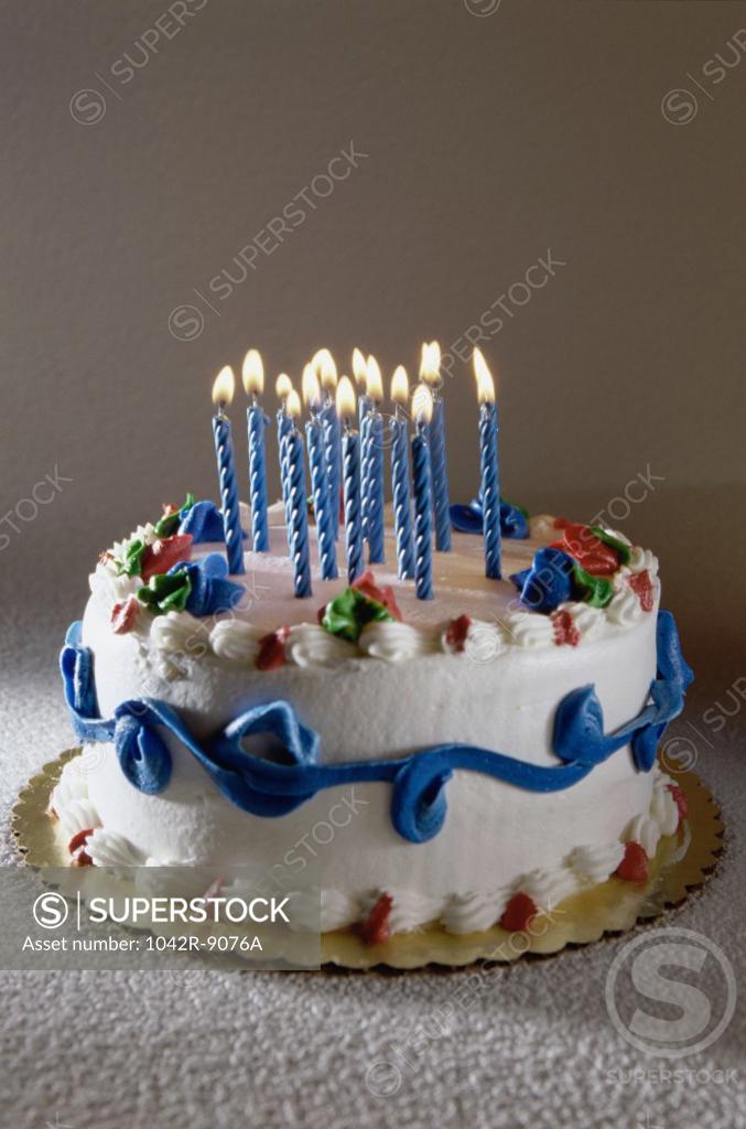 Stock Photo: 1042R-9076A Birthday cake with lit candles