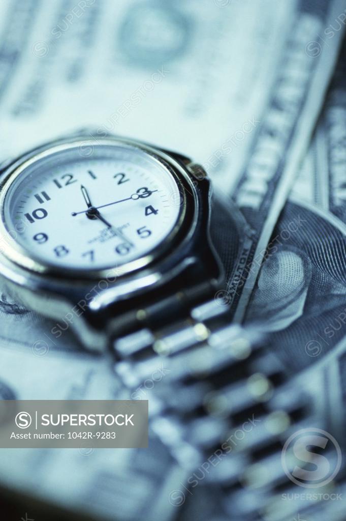 Stock Photo: 1042R-9283 Wristwatch over American dollar bills