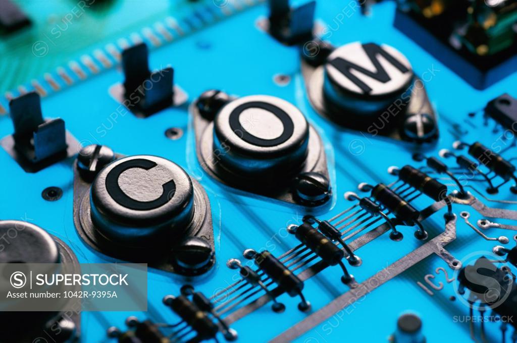 Stock Photo: 1042R-9395A .Com printed on components of a circuit board