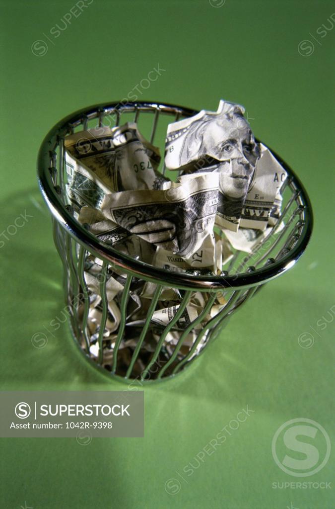 Stock Photo: 1042R-9398 Close-up of paper money in a wastepaper basket