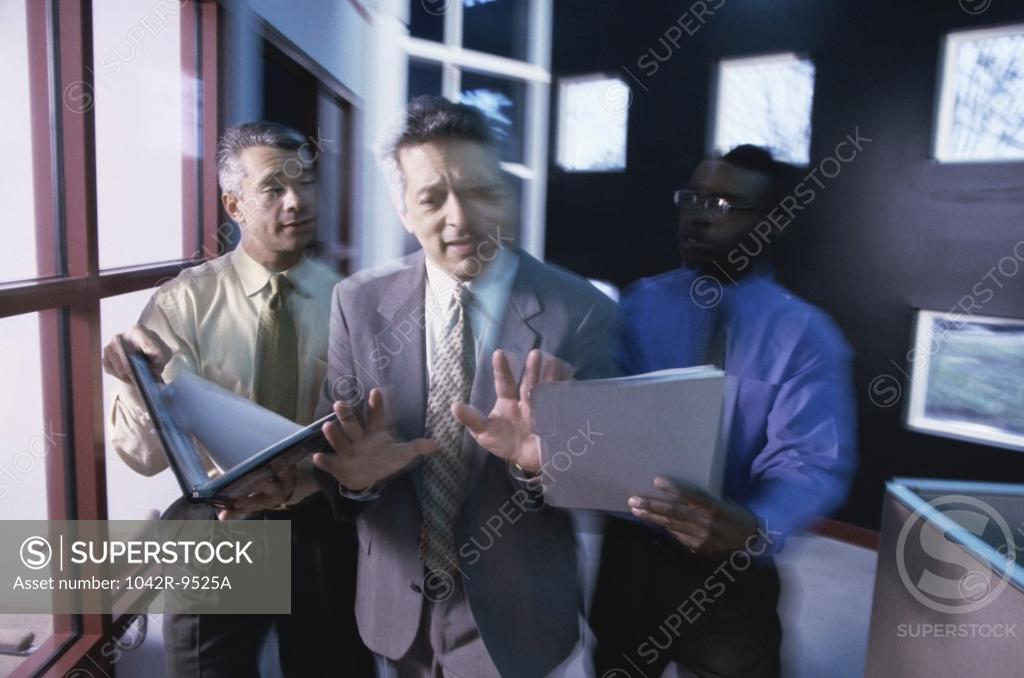 Stock Photo: 1042R-9525A Three businessmen discussing in an office