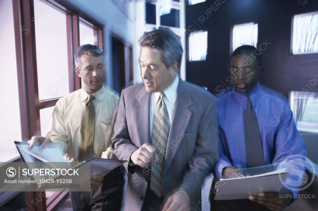 Stock Photo: 1042R-9525B Three businessmen discussing in an office