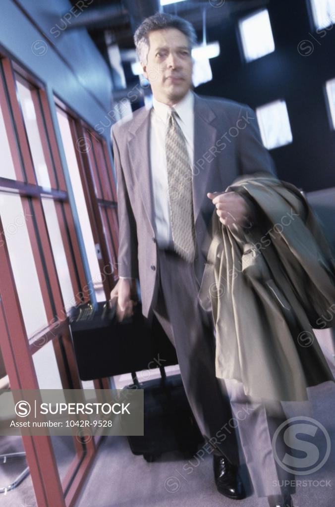 Stock Photo: 1042R-9528 Businessman pulling his luggage