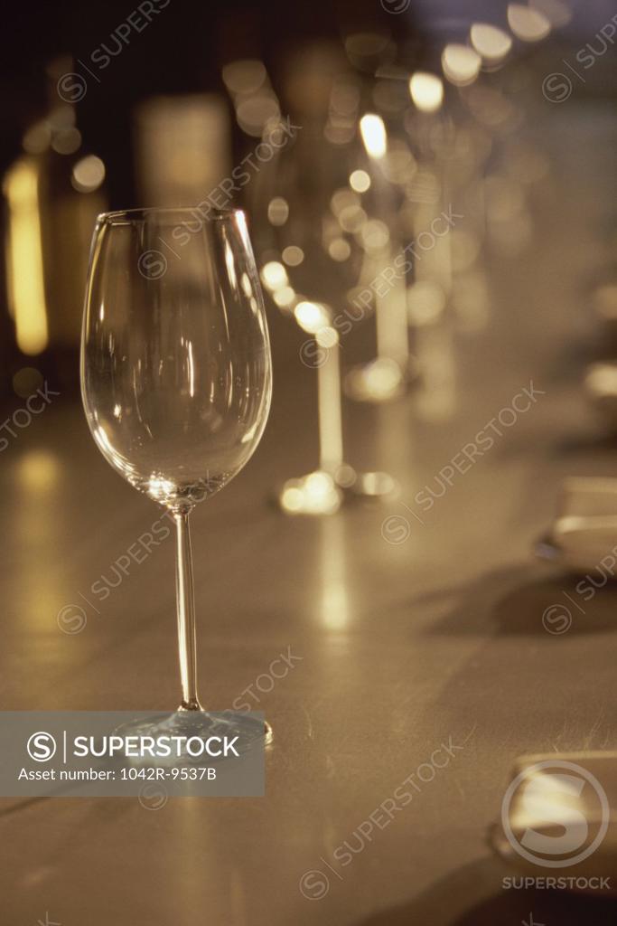 Stock Photo: 1042R-9537B Glasses in a row on a bar