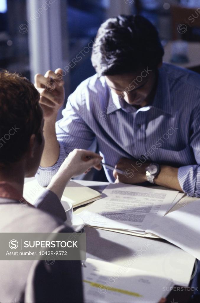 Stock Photo: 1042R-9572 Businessman and a businesswoman sitting together