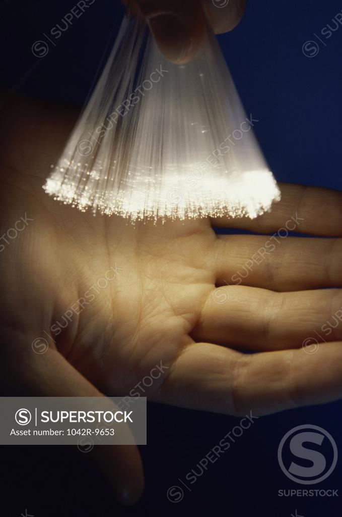 Stock Photo: 1042R-9653 Close-up of a person holding fiber optic cables