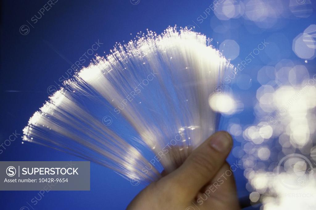 Stock Photo: 1042R-9654 Close-up of a person holding fiber optic cables