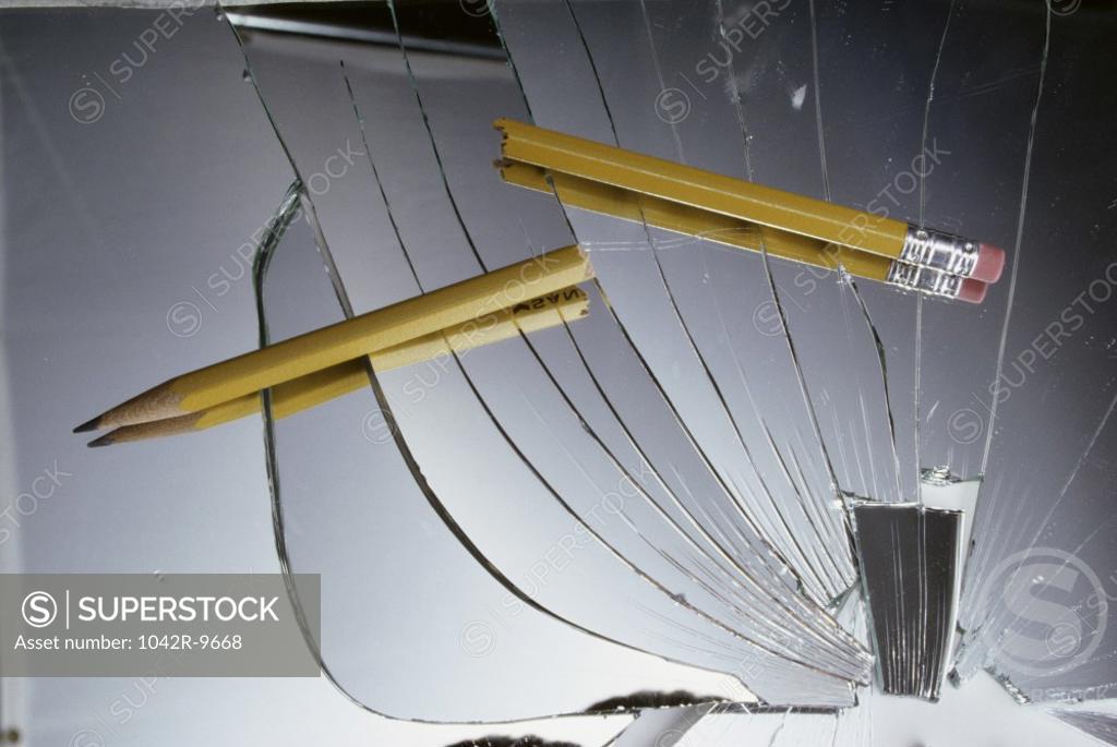 Stock Photo: 1042R-9668 Close-up of a pencil on a shattered mirror