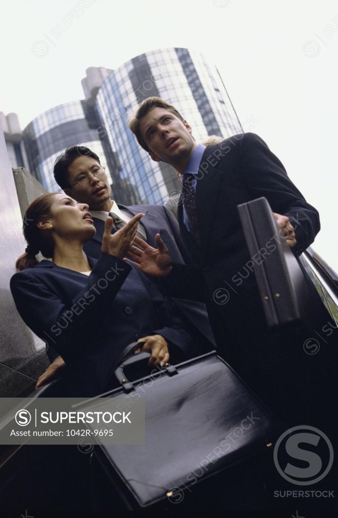 Stock Photo: 1042R-9695 Low angle view of business executives standing together