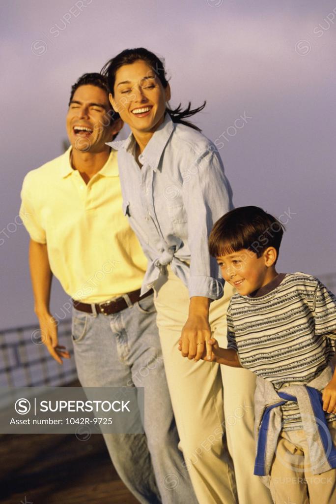 Stock Photo: 1042R-9725 Mother and father walking with their son