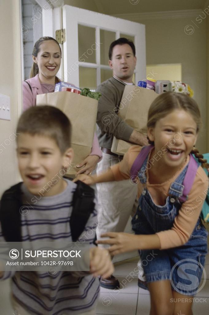 Stock Photo: 1042R-9769B Family arriving from grocery shopping