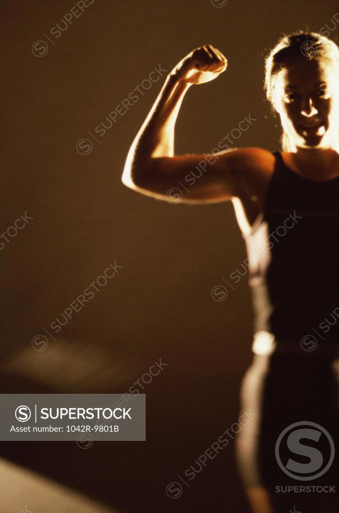Stock Photo: 1042R-9801B Woman flexing her biceps