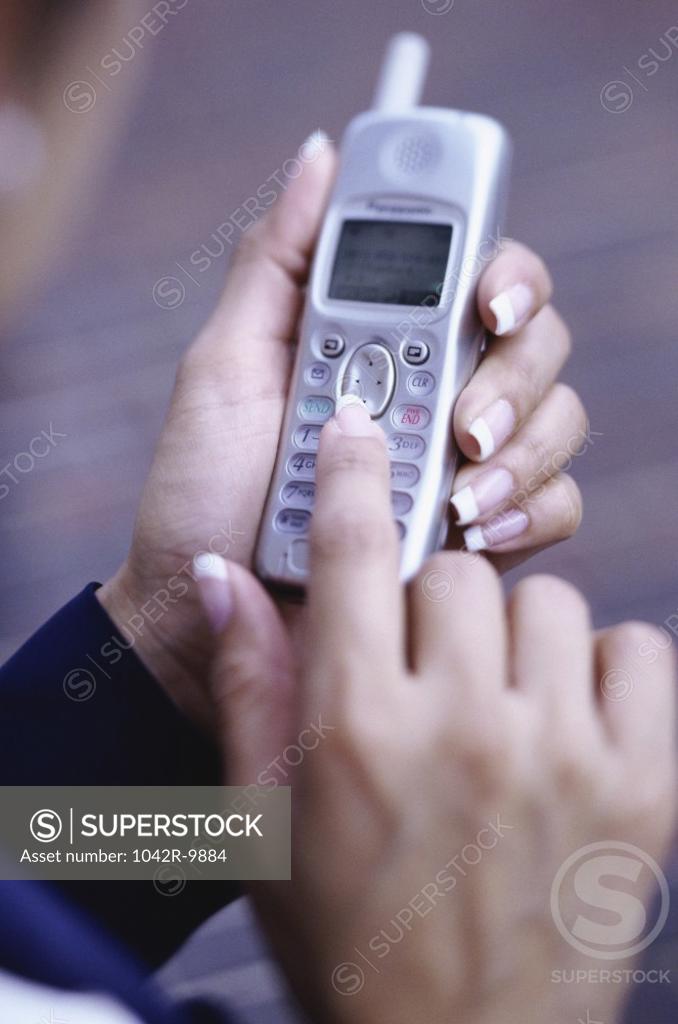 Stock Photo: 1042R-9884 Person operating a mobile phone