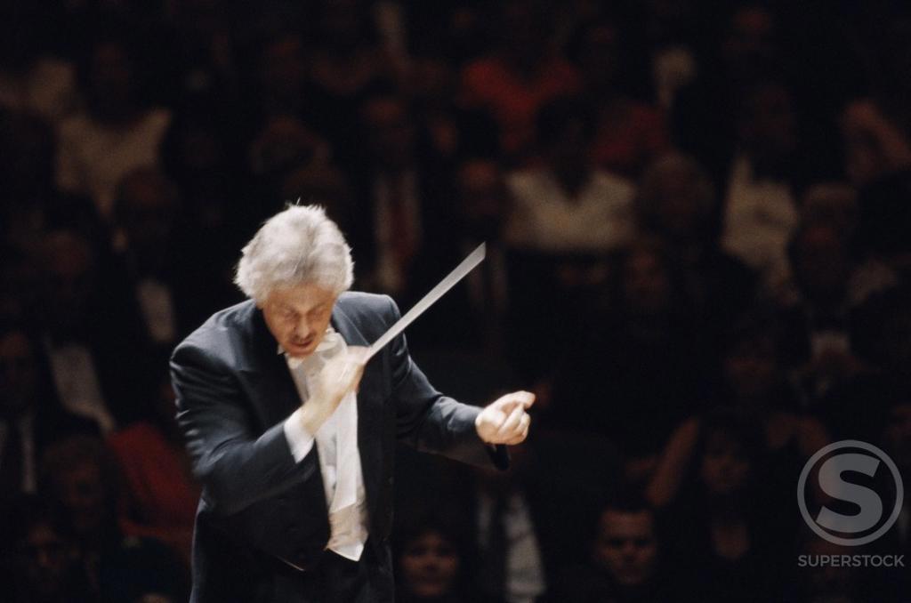 High angle view of a conductor leading a symphony orchestra