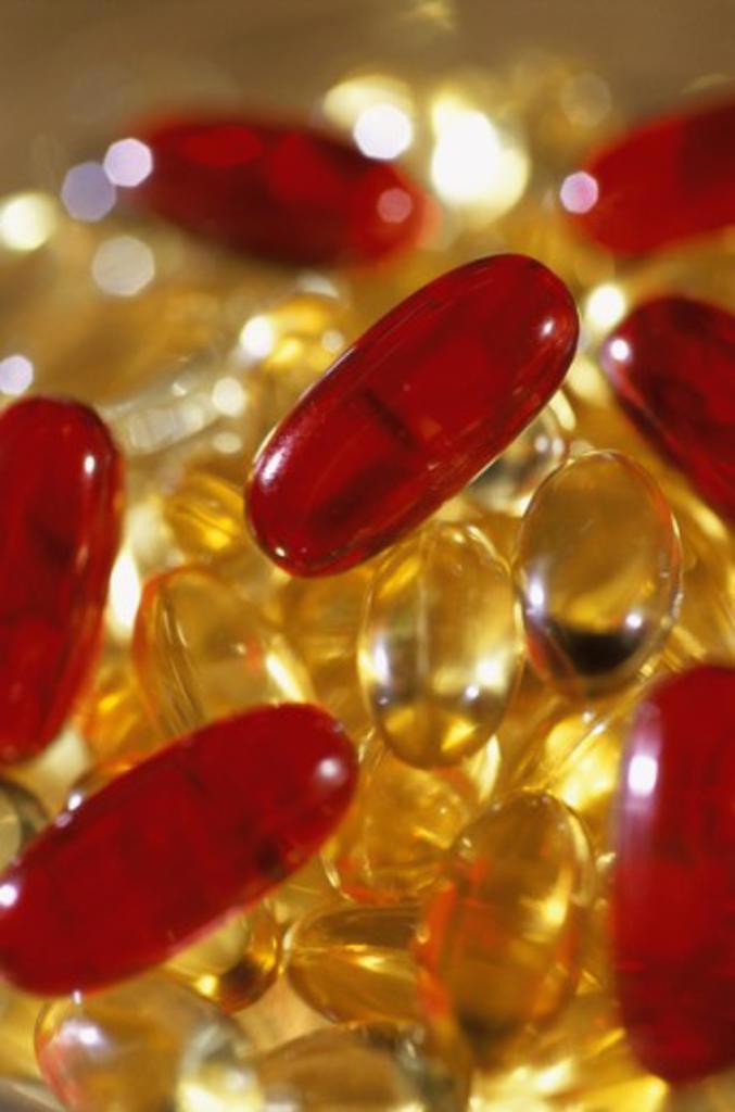 Close-up of a glass full of vitamin capsules