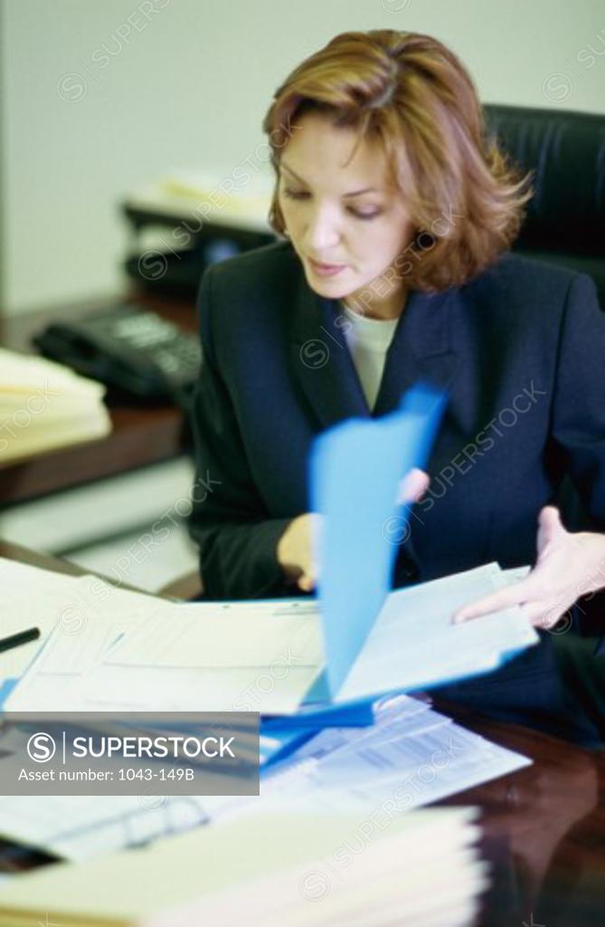 Stock Photo: 1043-149B Businesswoman reading a document