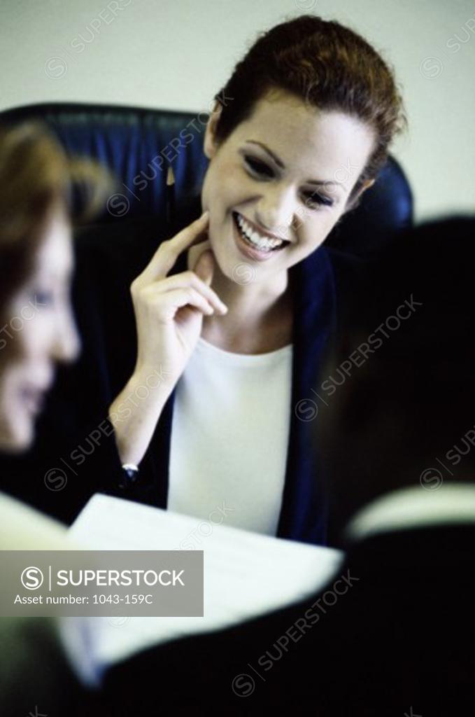 Stock Photo: 1043-159C Two businesswomen and a businessman in a meeting