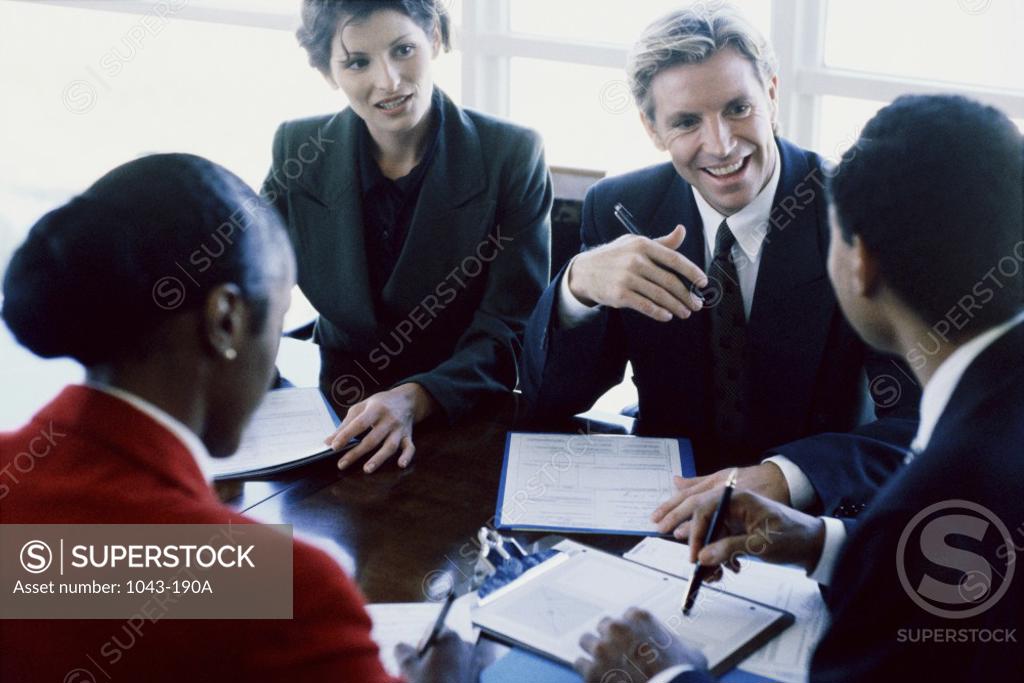 Stock Photo: 1043-190A Two businessmen and two businesswomen in an office
