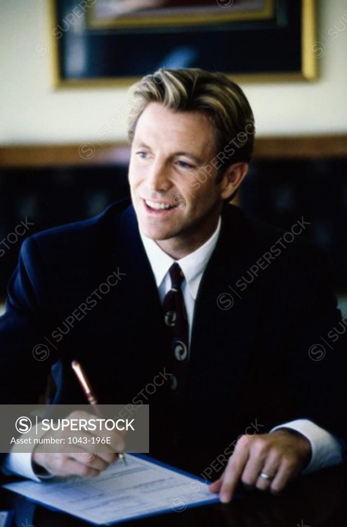 Stock Photo: 1043-196E Businessman holding a pen