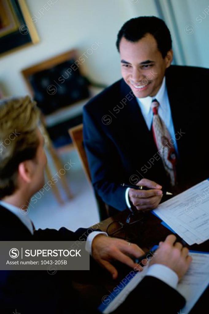 Stock Photo: 1043-205B Two businessmen talking in a meeting