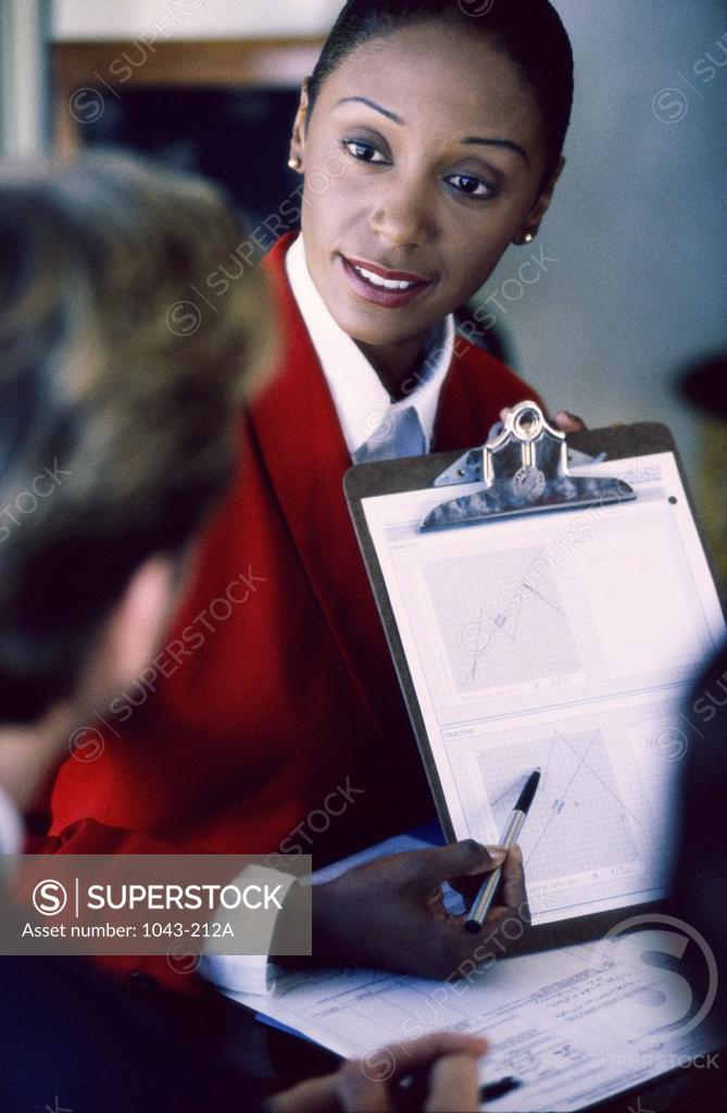 Stock Photo: 1043-212A Businesswoman holding a clipboard
