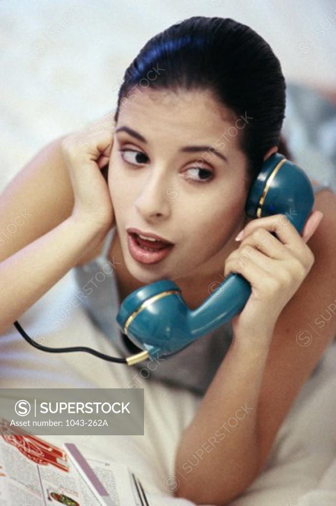 Stock Photo: 1043-262A Young woman talking on a telephone