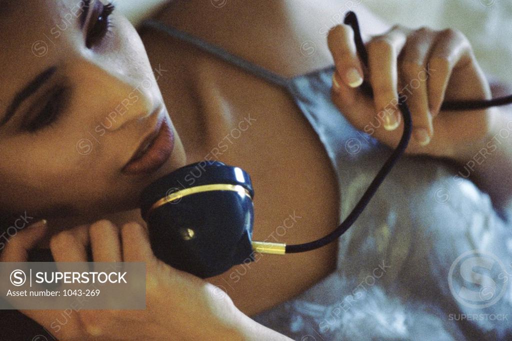 Stock Photo: 1043-269 Young woman talking on a telephone