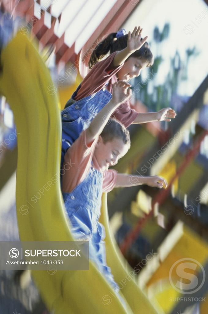 Stock Photo: 1043-353 Boy and girl playing on a slide