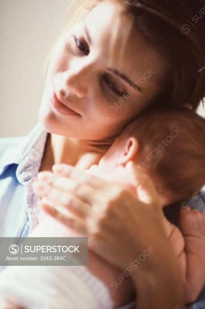 Stock Photo: 1043-384C Close-up of a mother carrying her baby boy