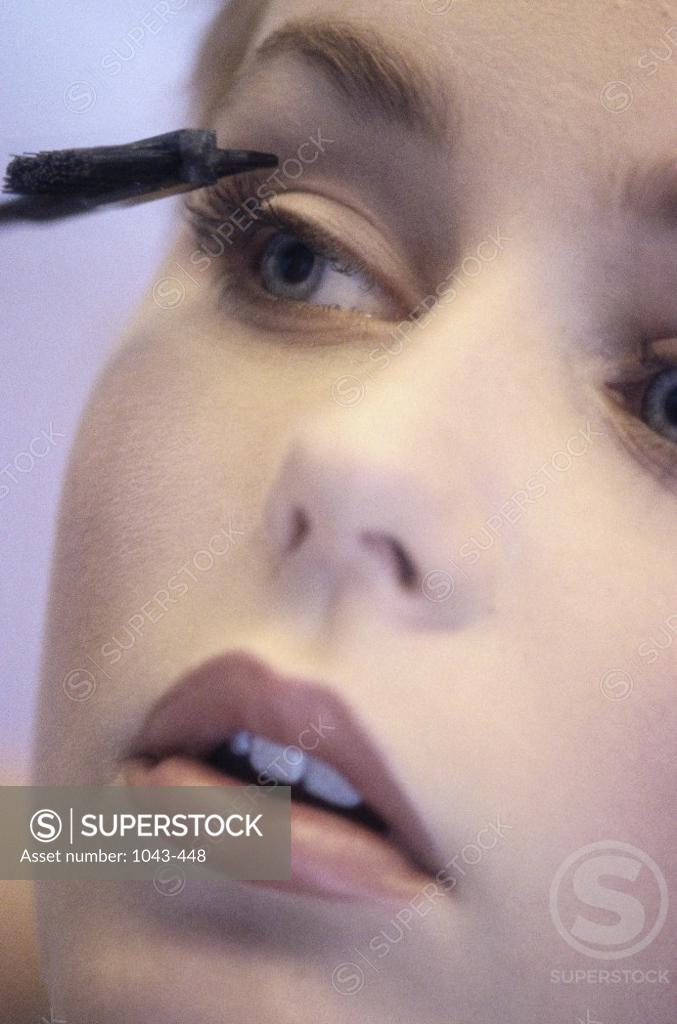 Stock Photo: 1043-448 Close-up of a young woman applying eye make-up