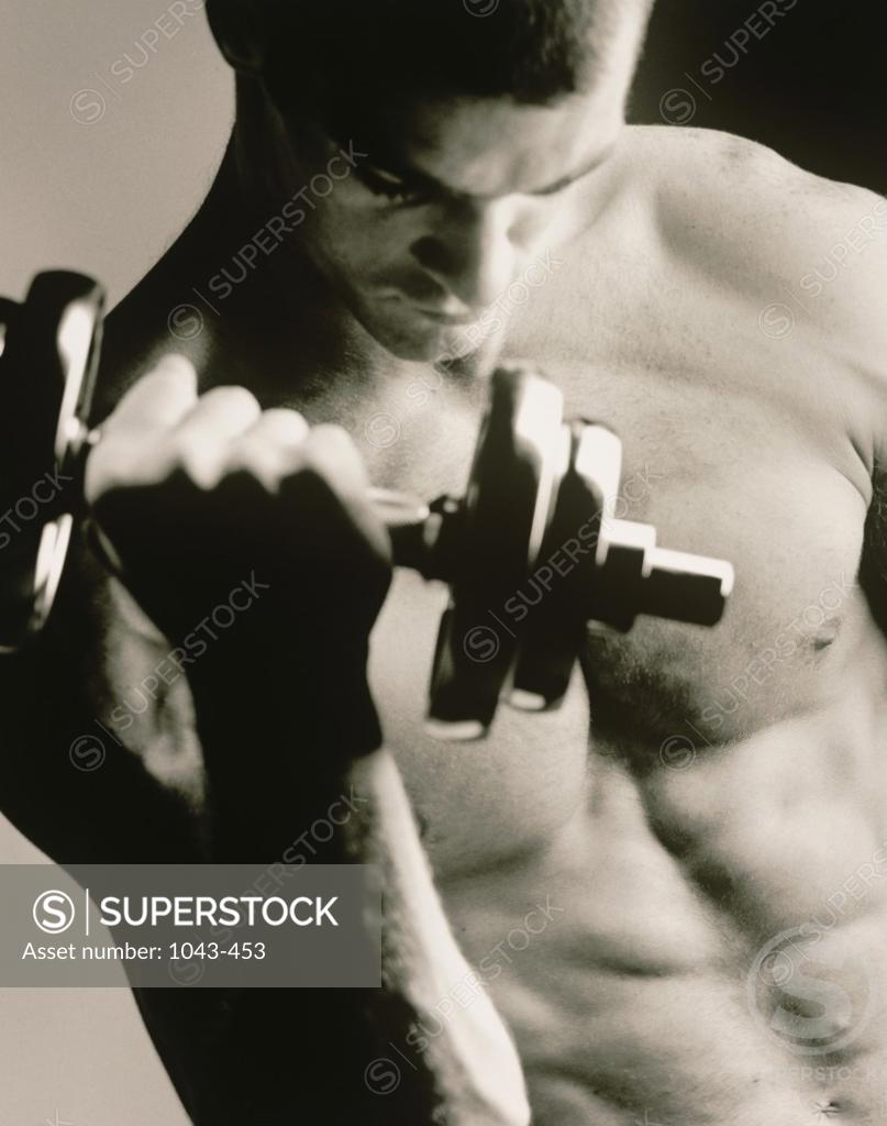 Stock Photo: 1043-453 Close-up of a young man working out with a dumbbell