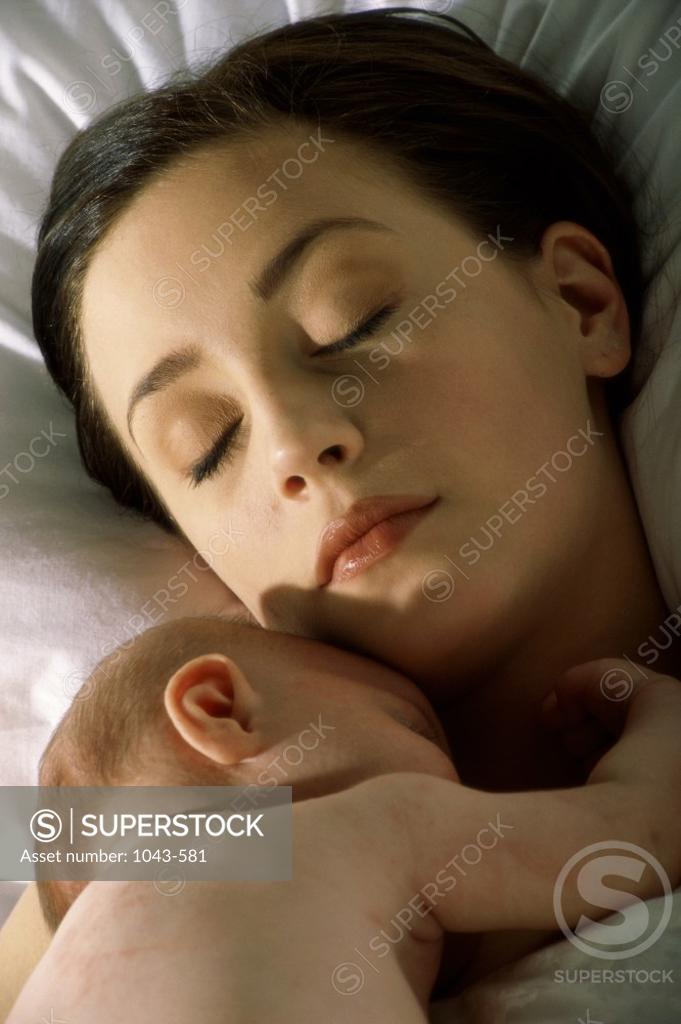 Stock Photo: 1043-581 Mother sleeping with her baby boy