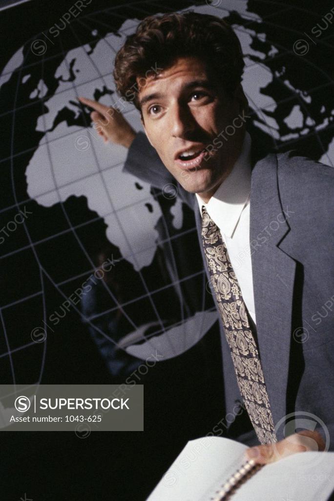 Stock Photo: 1043-625 Businessman pointing at a globe