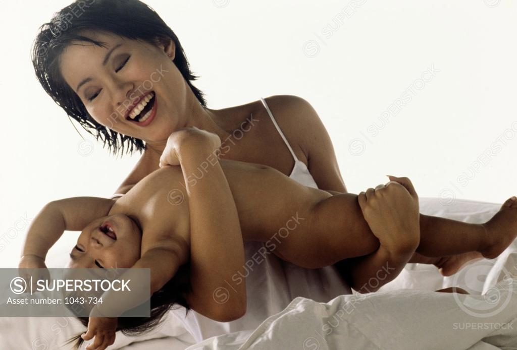 Stock Photo: 1043-734 Mother playing with her baby girl