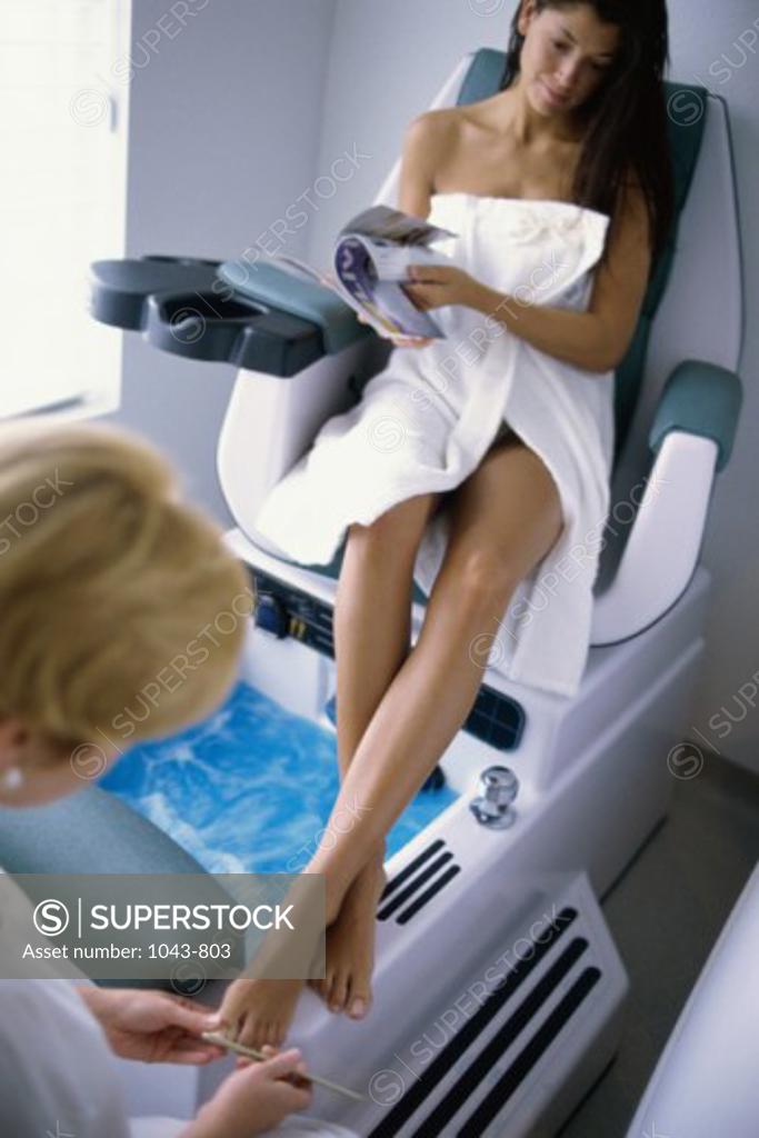 Stock Photo: 1043-803 Young woman getting a pedicure
