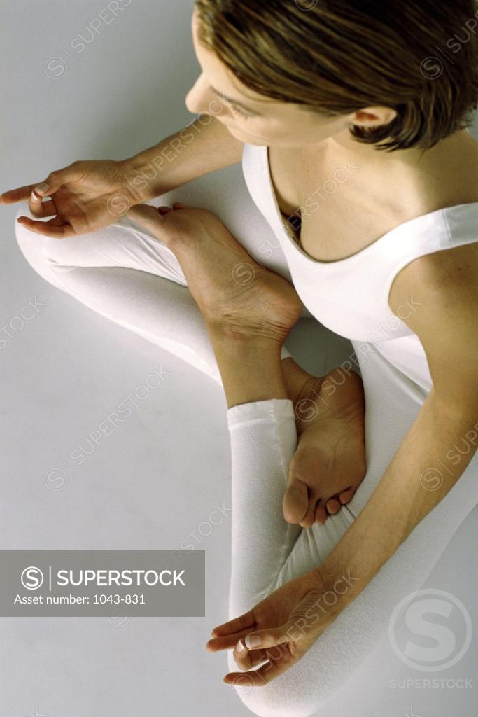 Stock Photo: 1043-831 High angle view of a young woman sitting in the lotus position