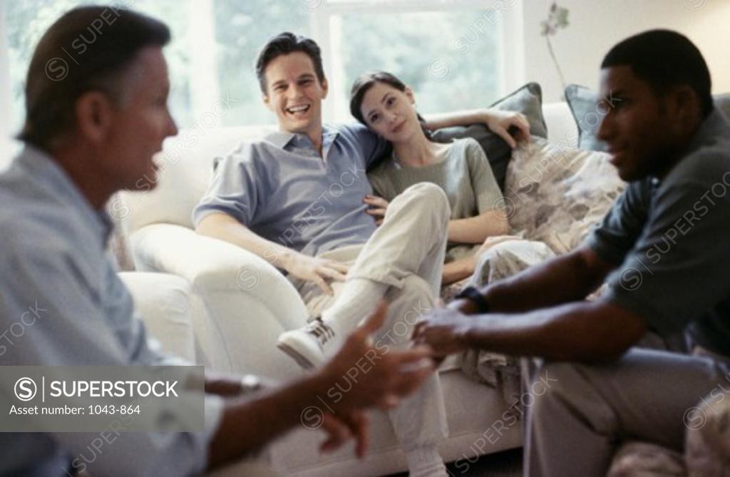 Stock Photo: 1043-864 Mid adult couple sitting with two mid adult men