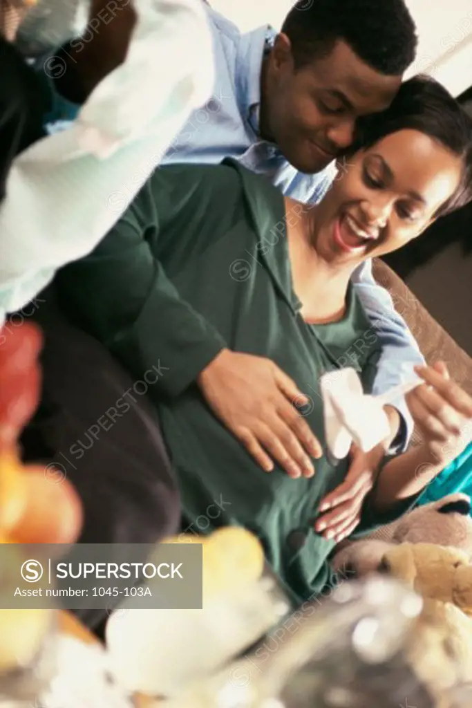 Young man touching his pregnant wife's abdomen