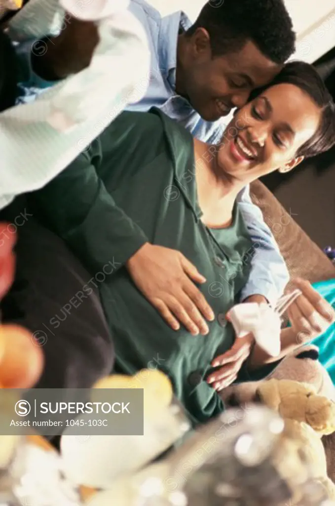 Young man touching his pregnant wife's abdomen
