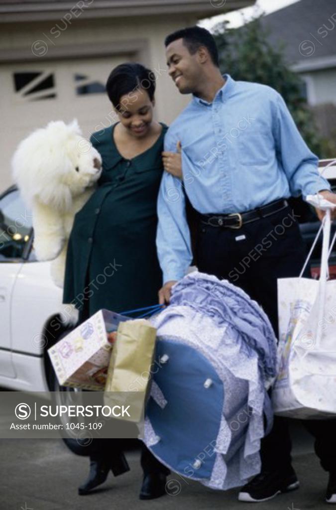 Stock Photo: 1045-109 Husband walking with his pregnant wife
