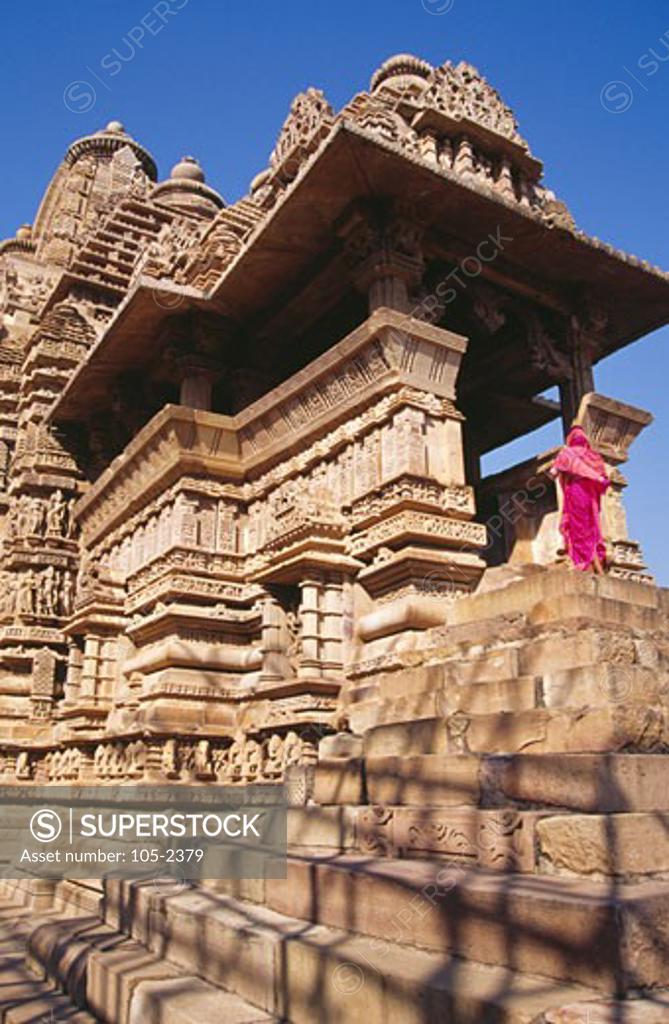 Stock Photo: 105-2379 India, Madhya Pradesh, Khajuraho, Rear view of woman walking at Lakshmana Temple