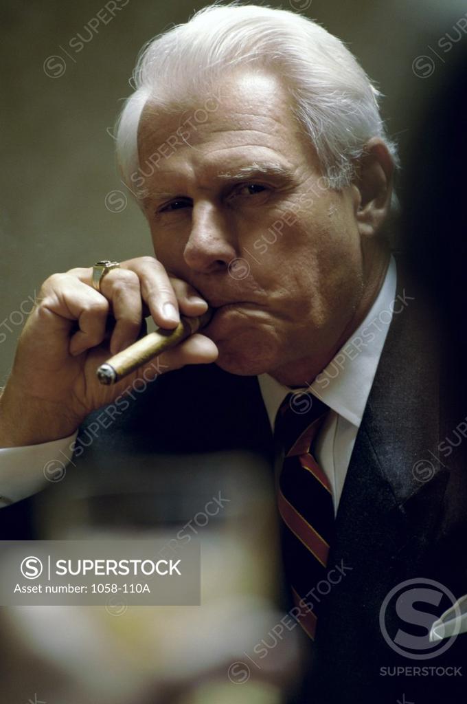 Stock Photo: 1058-110A Portrait of a senior man smoking a cigar