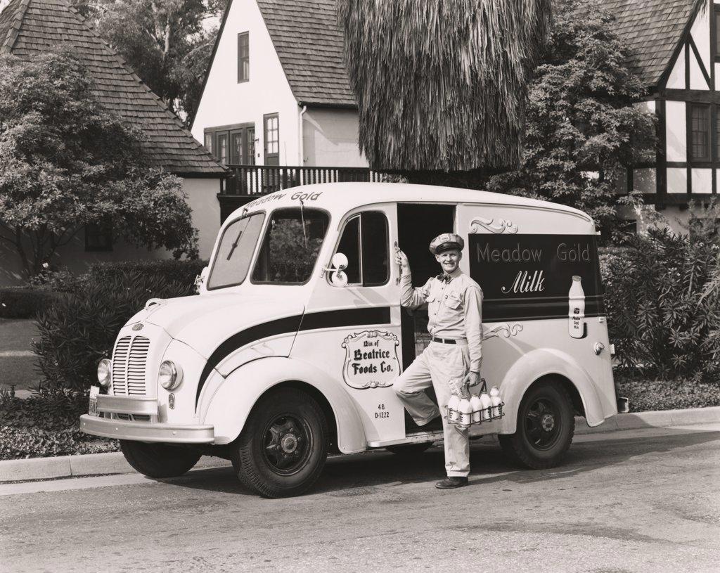 Milkman delivering milk, 1945 - SuperStock