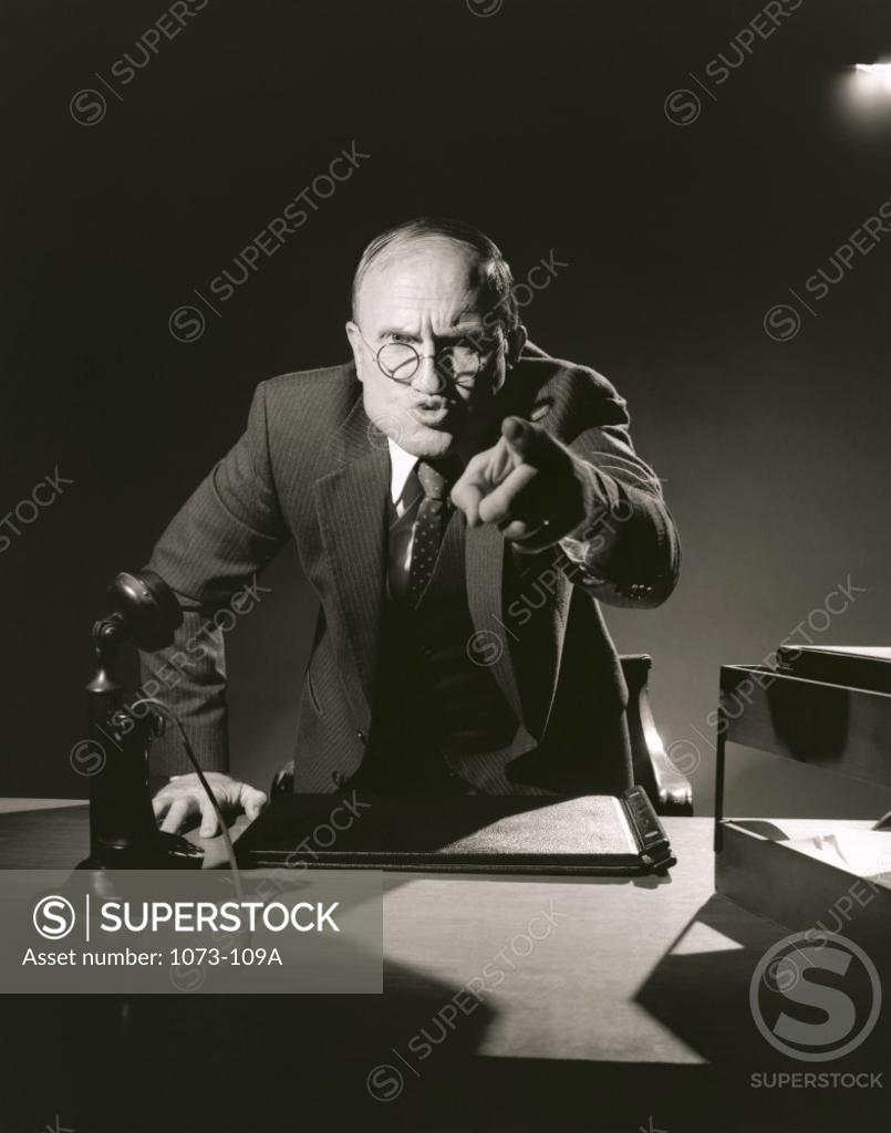 Stock Photo: 1073-109A Businessman pointing to camera in office